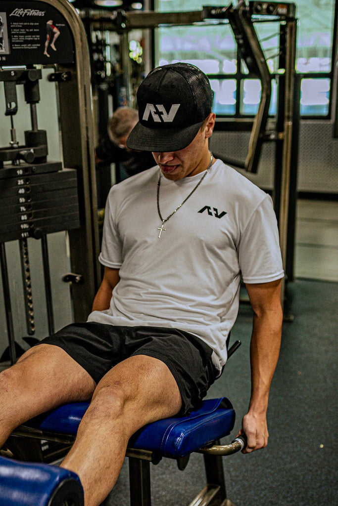 Person exercising on a leg press machine in a gym
