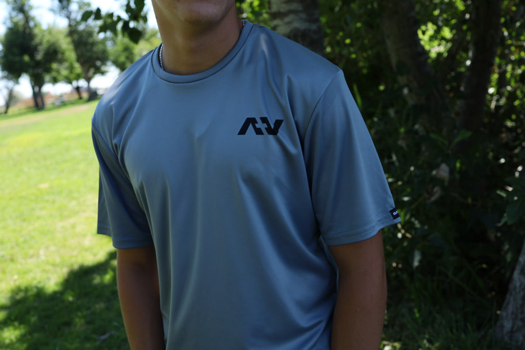 Person wearing a t-shirt with a logo in an outdoor setting